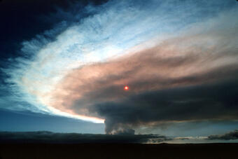 Sun seen through gas plume from Puu Ōō, viewed from Uwekahuna ov...